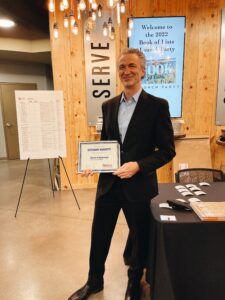 Giovanni Ruscitti with certificate at celebratory event